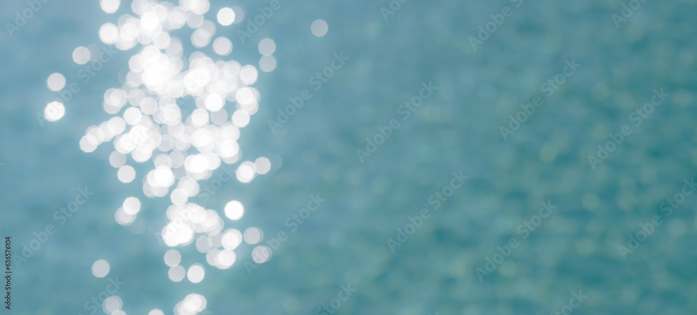 Tropical nature clean sea beach. Summer vacation travel blurred sun light blue ocean water sky and bokeh abstract background. Sunshine shades of blue artistic natural swimming pool texture Tropical nature clean sea beach. Summer vacation travel blurred sun light blue ocean water sky and bokeh abstract background. Sunshine shades of blue artistic natural swimming pool texture