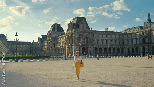 A young girl walking in the square near the Louvre. Paris
