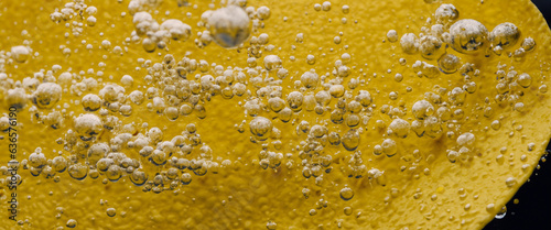 Deep fried potato chips under golden oil water. Frying rounded potatoes chip with hot boiling oil bubbles. Fast food and snack. Underwater cooking oily french fries or potatos chips in oils background photo