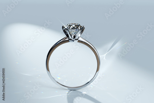 Engagement diamond ring standing in a spotlight on white background.
