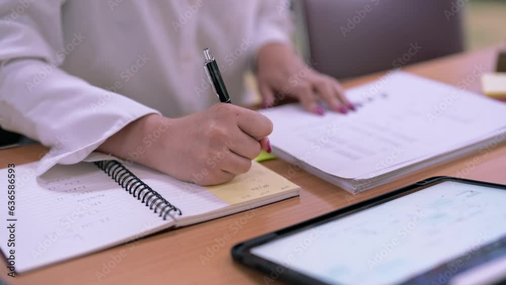 Young Asian Female student college do homework and reading a book for final exam at library, education concept. Young Asian Female student college do homework and reading a book for final exam at library, education concept.