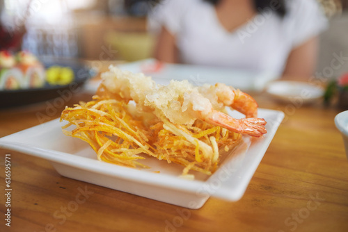 Food, sushi and cuisine on a table in a restaurant for a traditional asian dish or meal closeup. Seafood, fine dining and shrimp tempura on a plate in a chinese eatery for hunger or nutrition