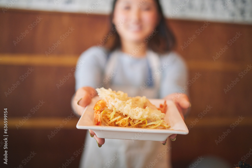 Hands, waitress and woman with seafood on plate, shrimp and tempura for eating at restaurant, cafe or store. Fish, food and person in sushi service, prawn and meat in fine dining, brunch and chips Hands, waitress and woman with seafood on plate, shrimp and tempura for eating at restaurant, cafe or store. Fish, food and person in sushi service, prawn and meat in fine dining, brunch and chips