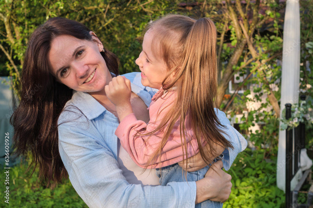 Lifelong Bonds: In the warmth of a sunlit garden, the foundation of a lifelong bond is formed, as a mother and daughter share joyous moments of connection. Lifelong Bonds: In the warmth of a sunlit garden, the foundation of a lifelong bond is formed, as a mother and daughter share joyous moments of connection.