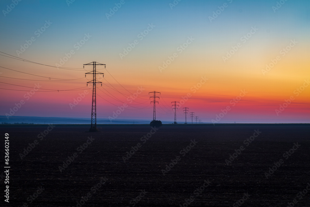 Foggy dawn over a high-voltage power line