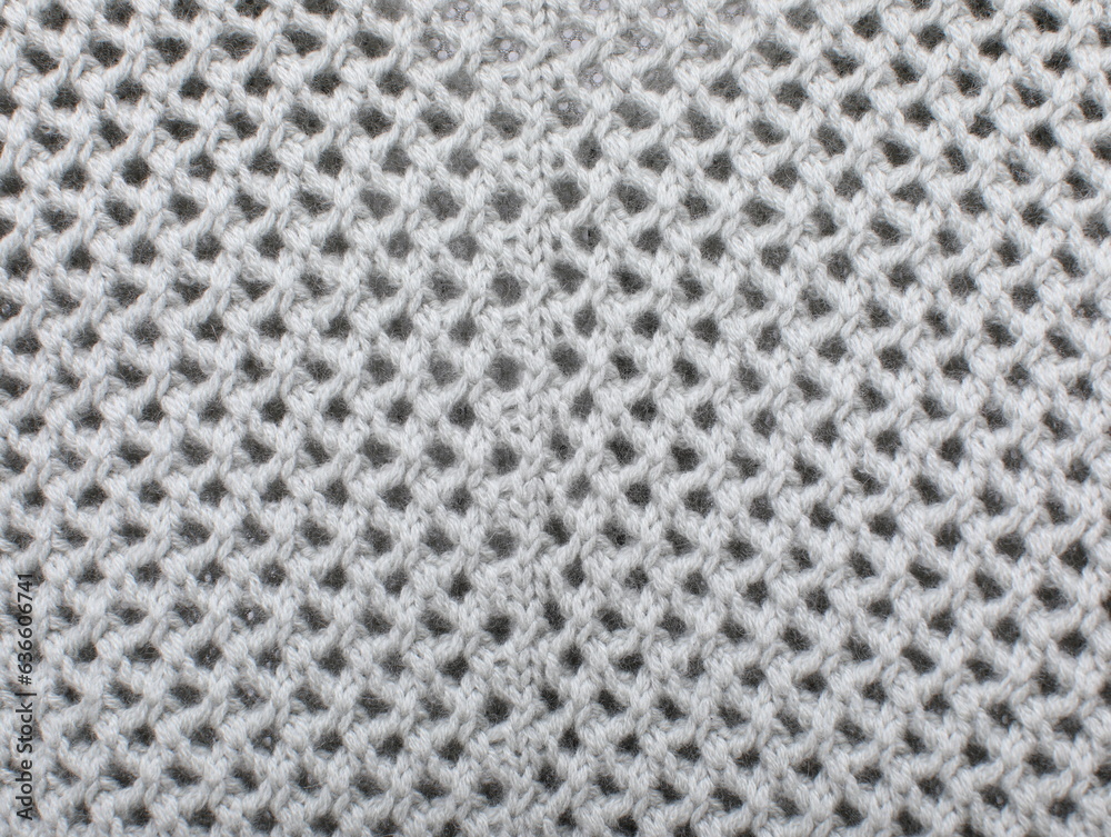 Soft gray color ribbed knitted fabric pattern close up as background Soft gray color ribbed knitted fabric pattern close up as background
