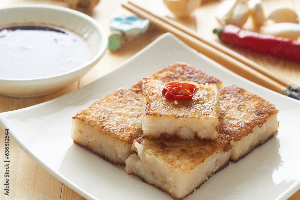 radish cake, turnip cake, daikon cake, wooden table, sauce chopsticks, steamer