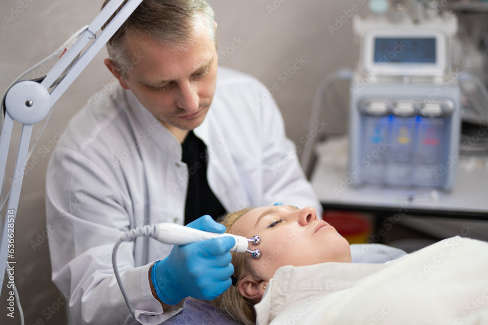 girl at a cosmetologist man during treatment procedures girl at a cosmetologist man during treatment procedures