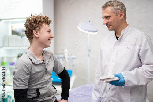 A man doctor talks to his boy patient and advises him on medicine