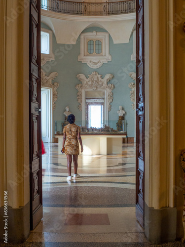 Young woman enjoying beautiful views of a palace in Stresa Italy in the Isola Bella island.