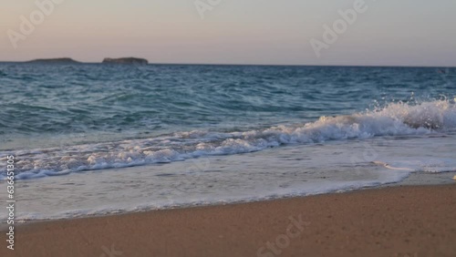 Mediterranean sea with waves in sunny day with island on background