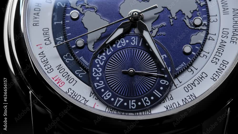 satin on watch face. time zones and countries on the watch face. Extreme closeup of second arrow passing by on blue clock face. Lengthwise view of luxury swiss watch. Closeup real time shot. satin on watch face. time zones and countries on the watch face. Extreme closeup of second arrow passing by on blue clock face. Lengthwise view of luxury swiss watch. Closeup real time shot.