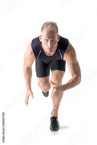 Photo of a blond man with blue eyes performing a dynamic jump in a studio setting