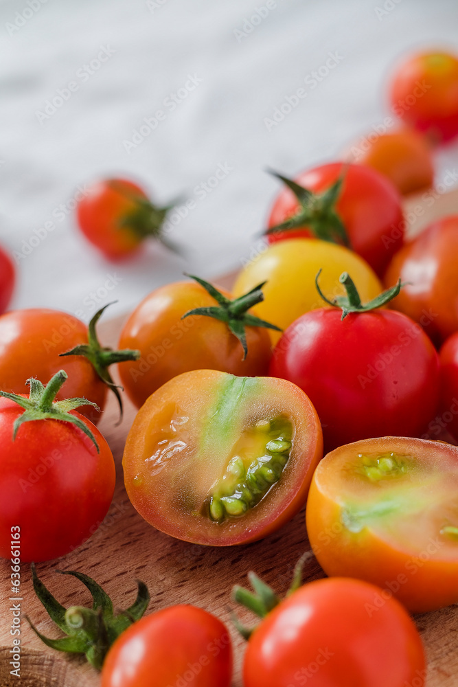 Organic chopped cherry tomatoes close up on a wooden board. Organic chopped cherry tomatoes close up on a wooden board.