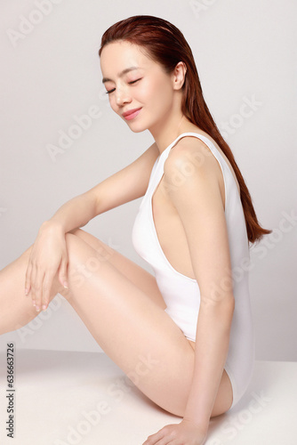 Tablou canvas Beautiful young asian woman with clean fresh skin & body on greay background