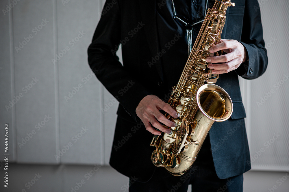 Fototapeta premium musician artist hands playing classical saxophone music instrument learning practicing jazz harmony melody on orchestra theatrical concert stage performance elegance gesture expression talent hobby