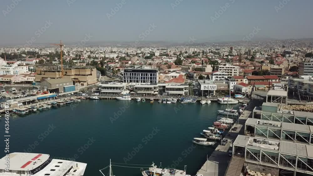 The boat parking near the sea. View from the sky. The boat parking of the resort town in Greece. The drone is flying back. The boat parking near the sea. View from the sky. The boat parking of the resort town in Greece. The drone is flying back.