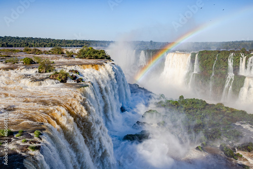 Perfect rainbow over Iguazu Waterfalls  one of the new seven natural wonders of the world in all its beauty viewed from the Brazilian side - traveling South America