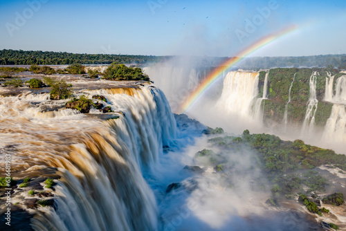 Perfect rainbow over Iguazu Waterfalls  one of the new seven natural wonders of the world in all its beauty viewed from the Brazilian side - traveling South America - long exposure