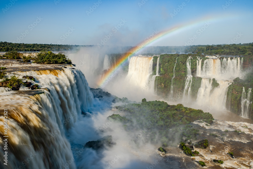 Perfect rainbow over Iguazu Waterfalls, one of the new seven natural wonders of the world in all its beauty viewed from the Brazilian side - traveling South America Perfect rainbow over Iguazu Waterfalls, one of the new seven natural wonders of the world in all its beauty viewed from the Brazilian side - traveling South America
