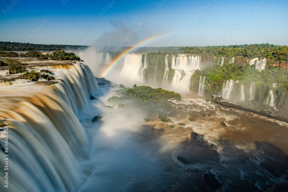 Perfect rainbow over Iguazu Waterfalls, one of the new seven natural wonders of the world in all its beauty viewed from the Brazilian side - traveling South America - long exposure Perfect rainbow over Iguazu Waterfalls, one of the new seven natural wonders of the world in all its beauty viewed from the Brazilian side - traveling South America - long exposure