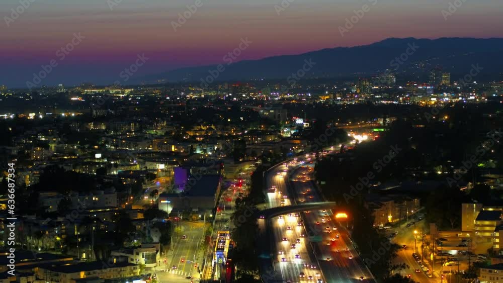 Aerial Tilt Down Shot Of Illuminated Railroad Tracks And Freeway In City Against Sky At Dusk - Culver City, California Aerial Tilt Down Shot Of Illuminated Railroad Tracks And Freeway In City Against Sky At Dusk - Culver City, California
