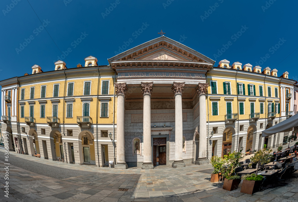 Naklejka premium Cuneo, Piedmont, Italy - August 16, 2023: Cathedral of Santa Maria del Bosco, Antonio Bono's facade with 4 Corinthian columns, portico and tympanum among historic buildings on Via Roma,fish eye vision