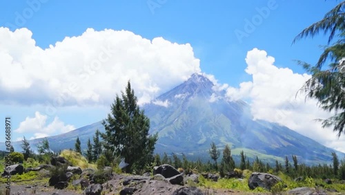 White ash clouds emit from Mayon volcano crater on a clear day photo