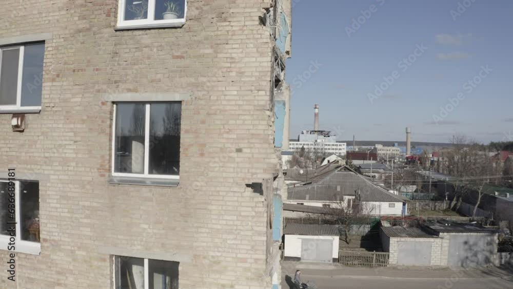 Damaged residential building in the Hostomel city, Kyiv region during the fighting after the Russian attack on Ukraine. Russian-Ukrainian war. Aerial. Fire in the house.
