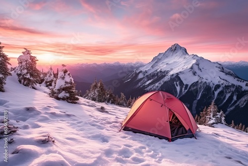 Tent camp in snowy mountains on misty sunrise background