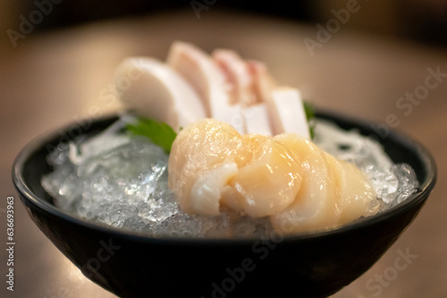 Sashimi scallop (Hotate) and Hamachi (Yellowtail fish) serve on ice with wasabi. Japanese food style. photo