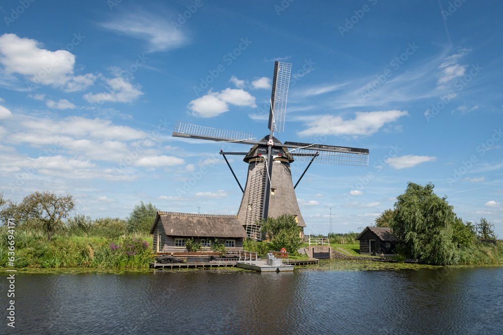 iconic smock ground sailer windmill in Kinderdijk Netherlands. Landmark buildings originally made to pump water out of low land polder to preserve land reclaimed from the sea