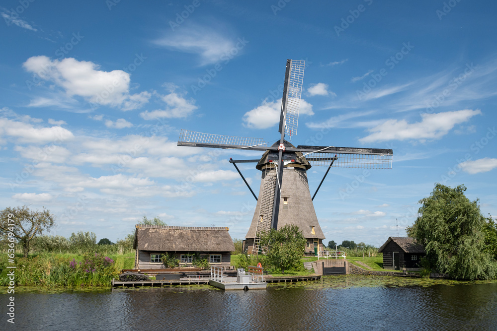 iconic smock ground sailer windmill in Kinderdijk Netherlands. Landmark buildings originally made to pump water out of low land polder to preserve land reclaimed from the sea