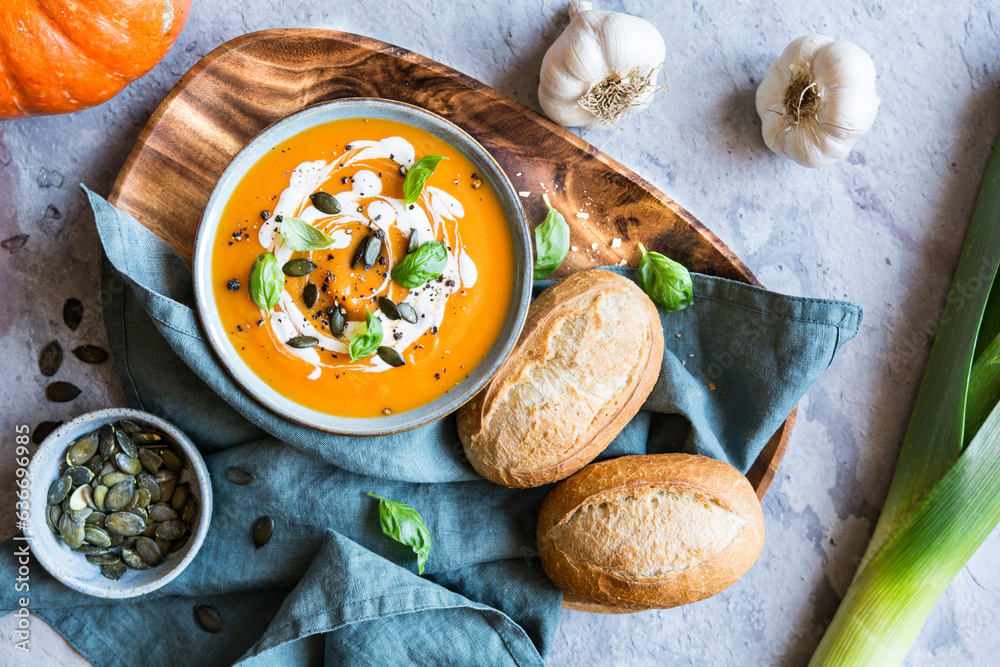 Pumpkin and Tomato cream soup topped with sour cream, pumpkin seeds and basil Pumpkin and Tomato cream soup topped with sour cream, pumpkin seeds and basil