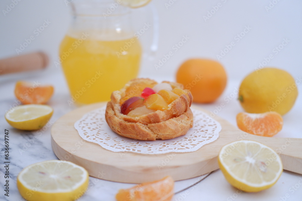Homemade lemon tart with fresh fruit and orange juice on white background Homemade lemon tart with fresh fruit and orange juice on white background
