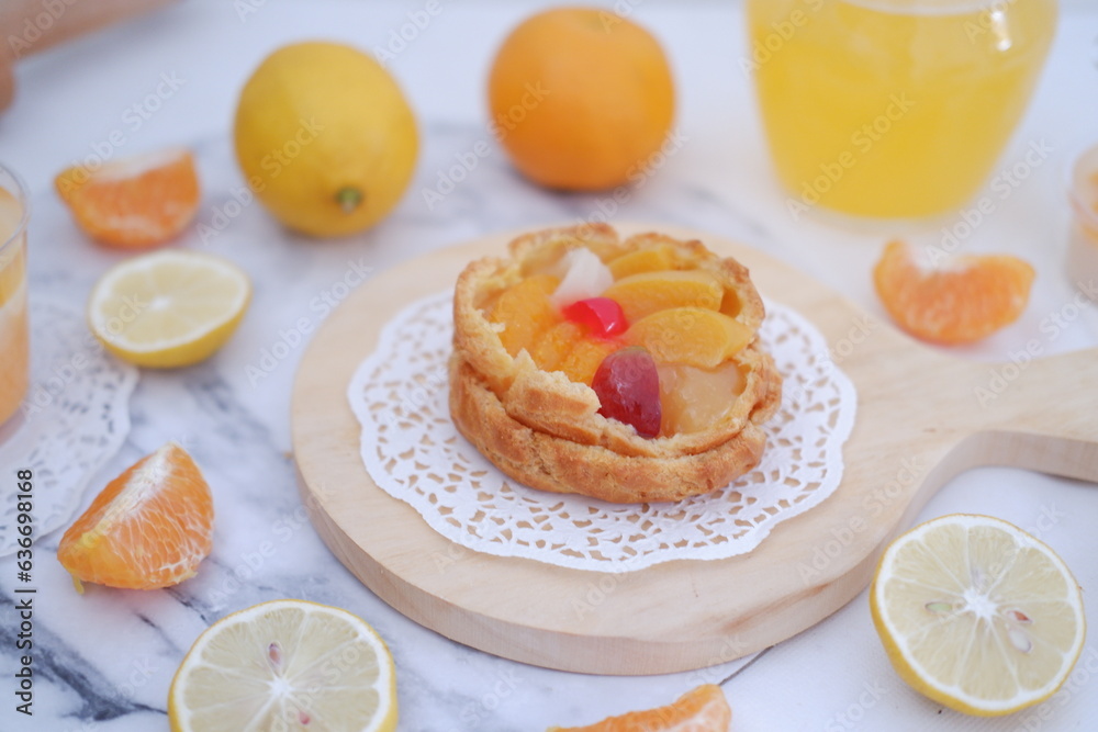 Homemade lemon tart with fresh fruit and orange juice on white background Homemade lemon tart with fresh fruit and orange juice on white background