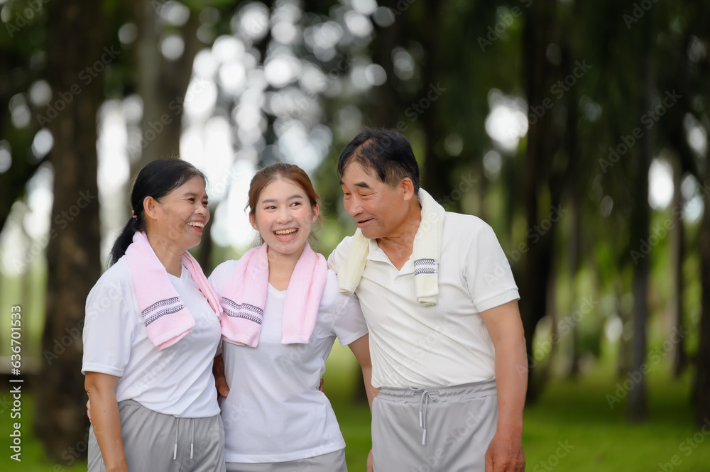 Happy Asian Family Showing Each Other Love and Concern in the Park while Walking for Exercise. Family Bonding Without Bounds, Creating Family Happiness in the Outdoors. Happy Asian Family Showing Each Other Love and Concern in the Park while Walking for Exercise. Family Bonding Without Bounds, Creating Family Happiness in the Outdoors.