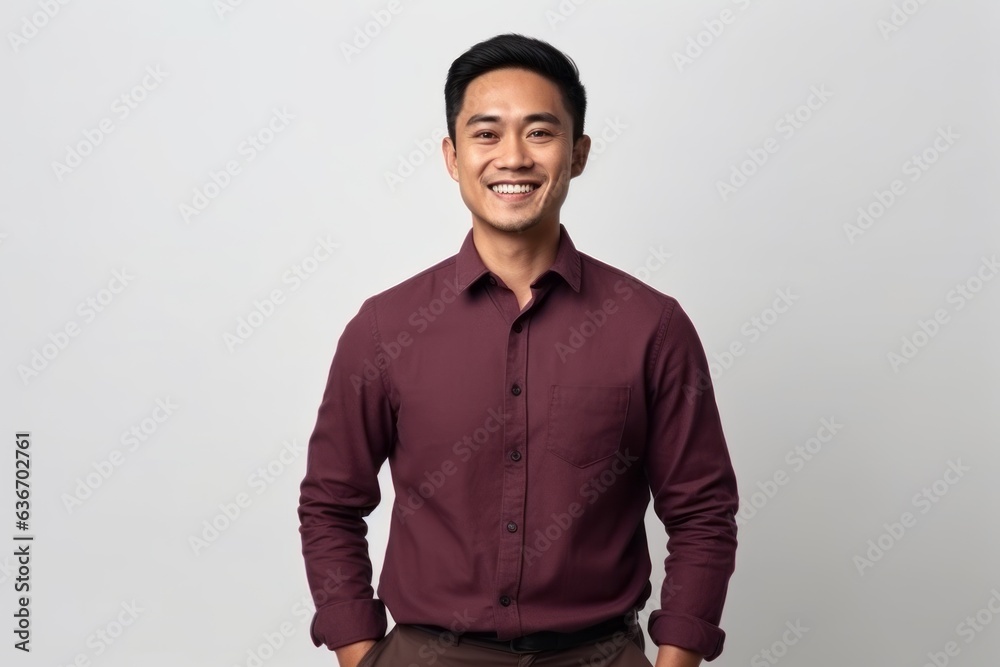 Portrait of a happy young asian man standing against white background Portrait of a happy young asian man standing against white background