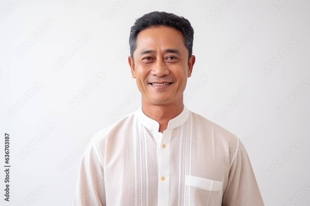 Portrait of happy Asian man in white shirt looking at camera and smiling.