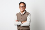 Portrait of happy Asian man in eyeglasses with arms crossed