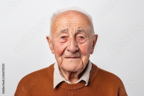 Medium shot portrait of a 100-year-old elderly Russian man in a white background wearing a cozy sweater