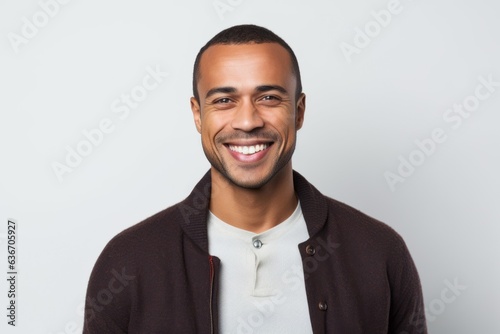 Portrait of happy young african american man smiling against white background