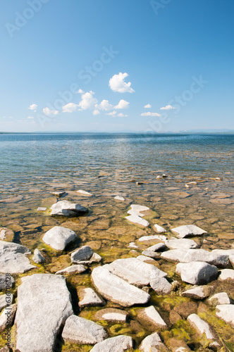 Summer view of lake Uvildy with its rocky shore in the foreground, South Urals, Russia photo