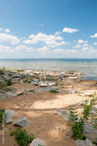 Sandy beach with rocks at Uvildy lake in summer, South Urals, Russian Federation photo