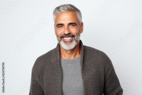 Portrait of a handsome mature man smiling at camera over white background