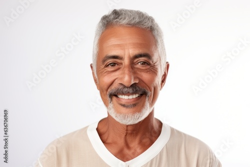 Portrait of smiling senior man looking at camera isolated over white background