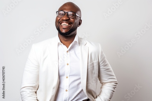 Lifestyle portrait of a Nigerian man in his 40s in a white background wearing a chic cardigan photo