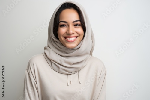Portrait of a beautiful young muslim woman in hijab smiling.