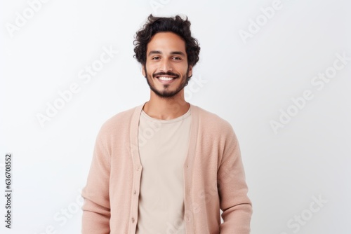 Portrait of a handsome young man smiling at camera over white background