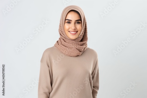 Portrait of beautiful young muslim woman in hijab smiling at camera